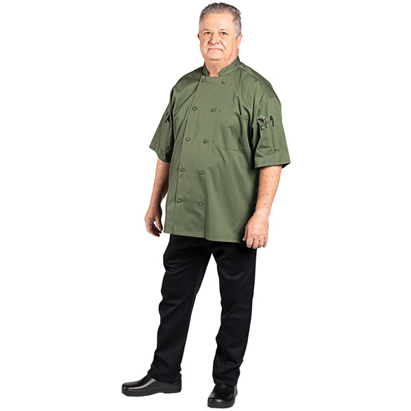 A man wearing a sea green short sleeve chef coat.