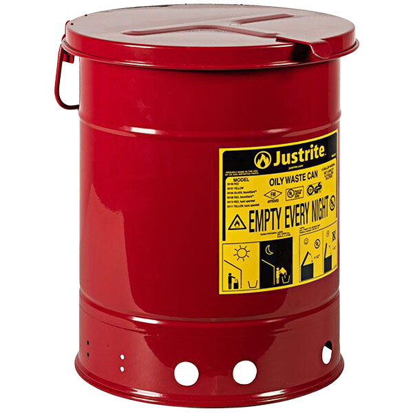 A red barrel with a yellow label that says "Oily Waste"