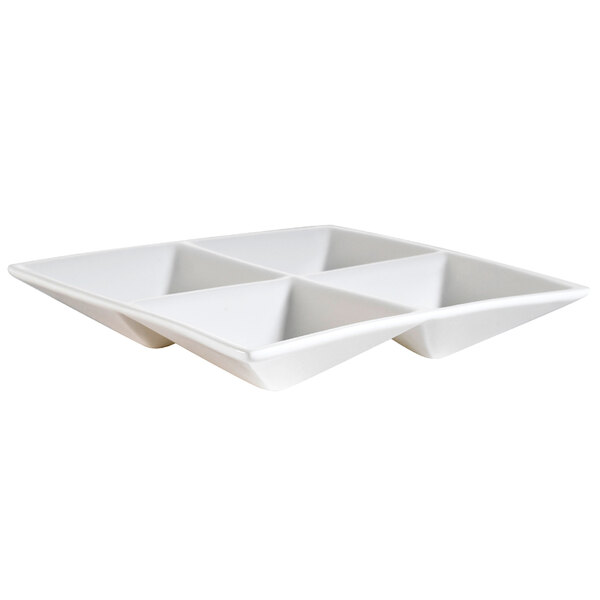 A bone white square porcelain dish with 4 compartments.