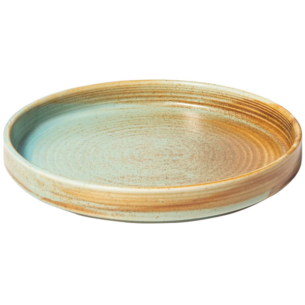 A Bon Chef Tavola Lago teal porcelain salad plate with a brown and green rim.