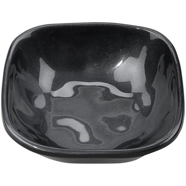 A black irregular square bowl with a shiny surface.