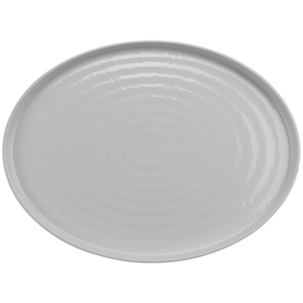 A white oval platter with a circular pattern.