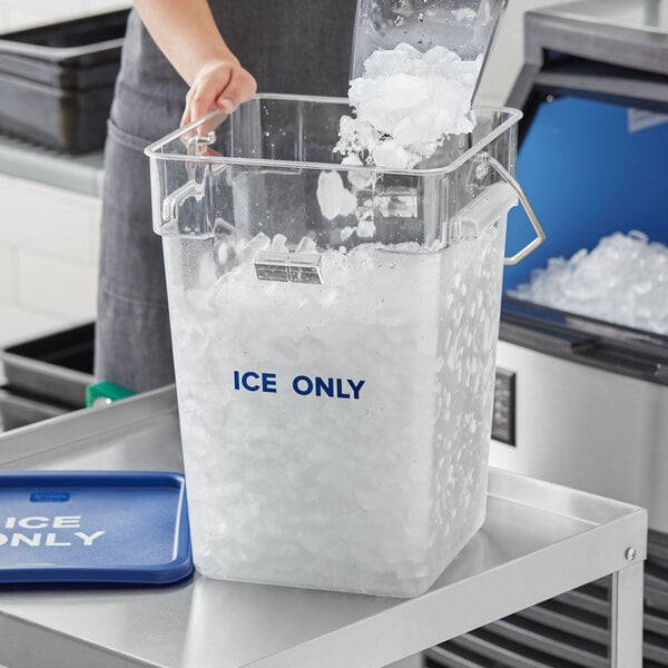 A woman pouring ice from a clear container into a Vigor ice tote.