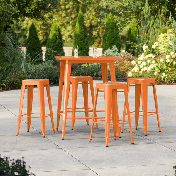 Lancaster Table & Seating Alloy Series 31 1/2" x 31 1/2" Amber Orange Bar Height Outdoor Table with 4 Backless Barstools