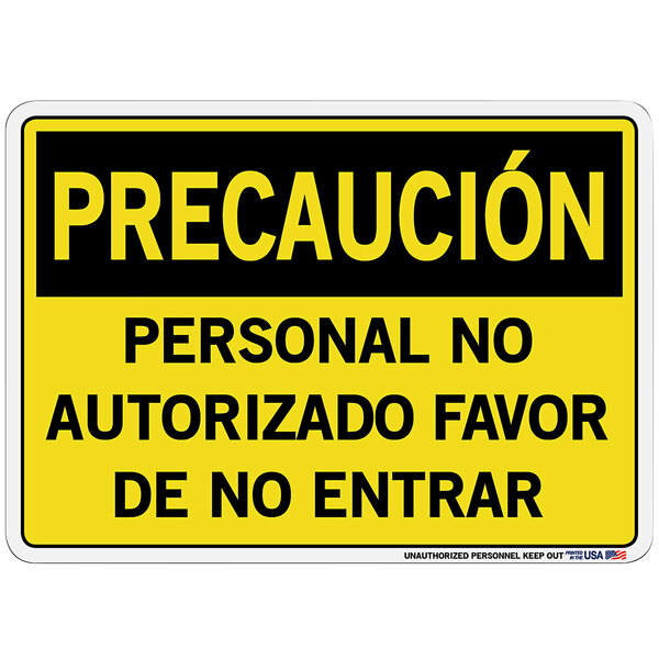 A yellow sign with black letters that says "Precauci&#243;n Personal No Autorizado Favor De No Entrar"