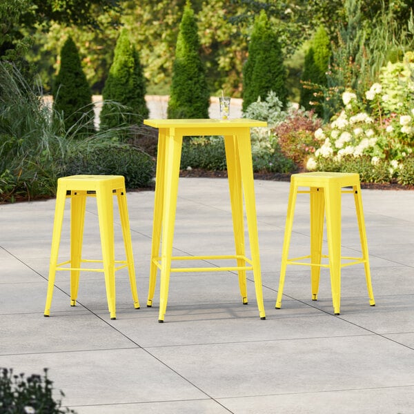 Lancaster Table & Seating Alloy Series 23 1/2" x 23 1/2" Citrine Yellow Bar Height Outdoor Table with 2 Backless Barstools
