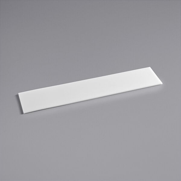 A white rectangular Avantco cutting board surface on a gray surface.