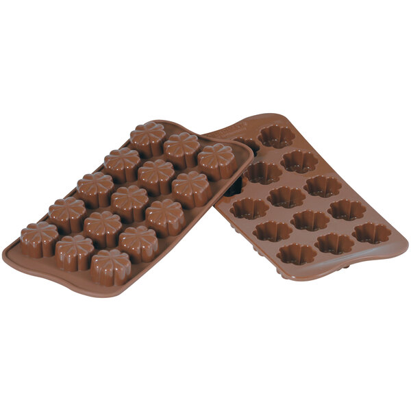 A Silikomart brown silicone chocolate mold with flower-shaped compartments.