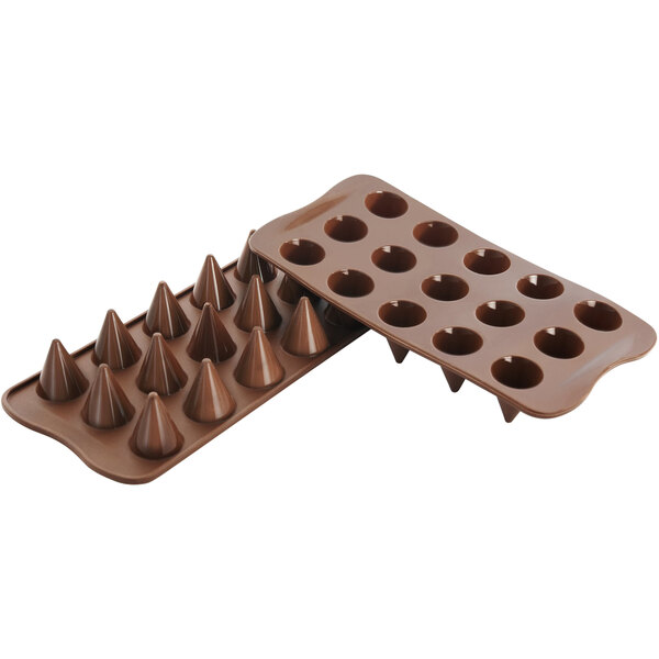 A brown silicone Silikomart chocolate mold with holes.