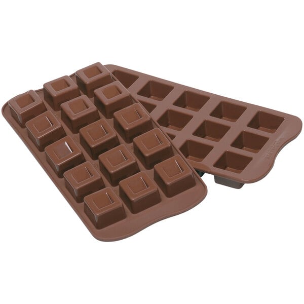 A close-up of a Silikomart Cubo brown silicone chocolate mold with 15 compartments.