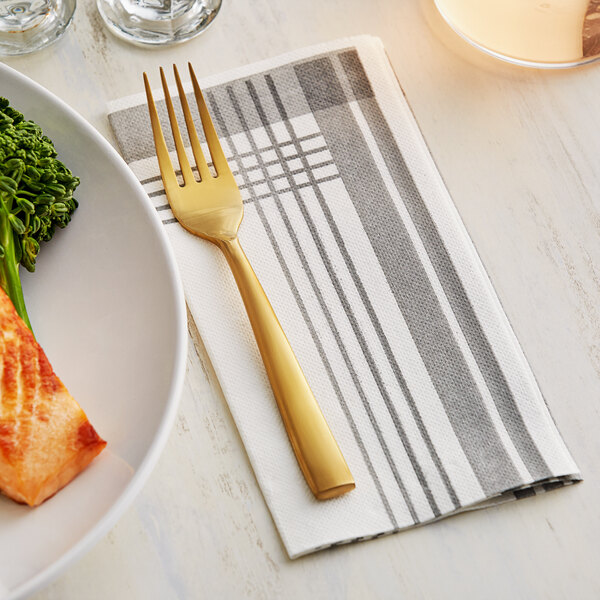 A Hoffmaster FashnPoint tissue dinner napkin with a fork on a plate with broccoli and fish.