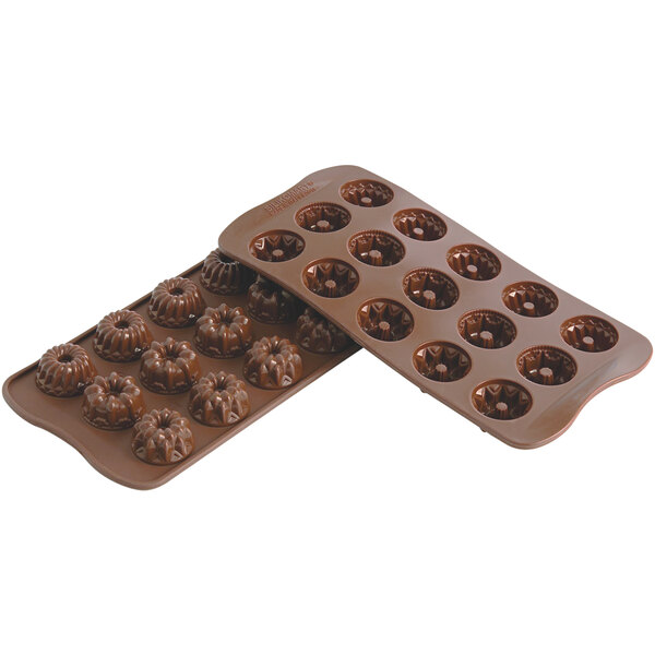 A close-up of a Silikomart silicone chocolate mold filled with chocolate balls.
