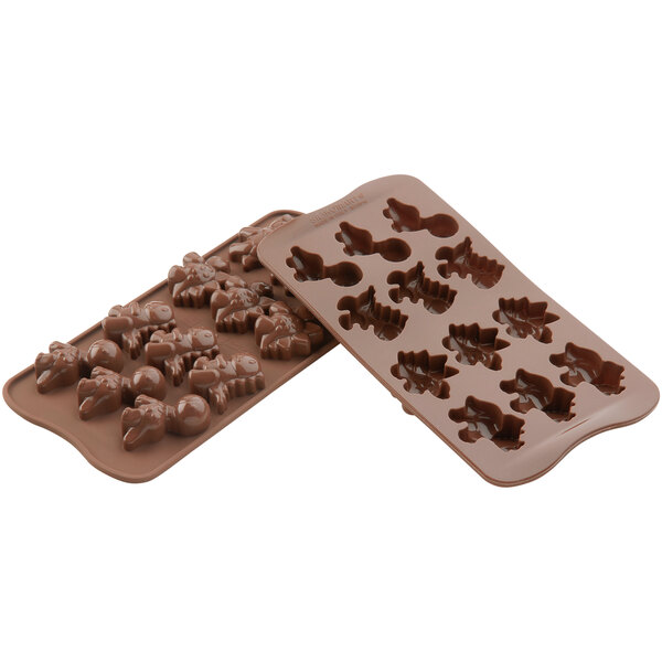 A Silikomart brown silicone chocolate mold with dinosaur shapes.