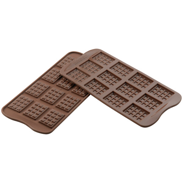 A Silikomart brown silicone chocolate mold with square compartments.