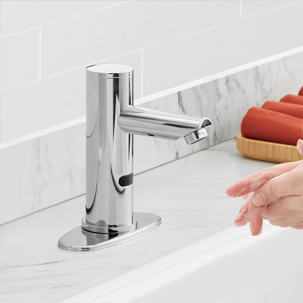A person washing their hands with a Waterloo hands-free faucet.