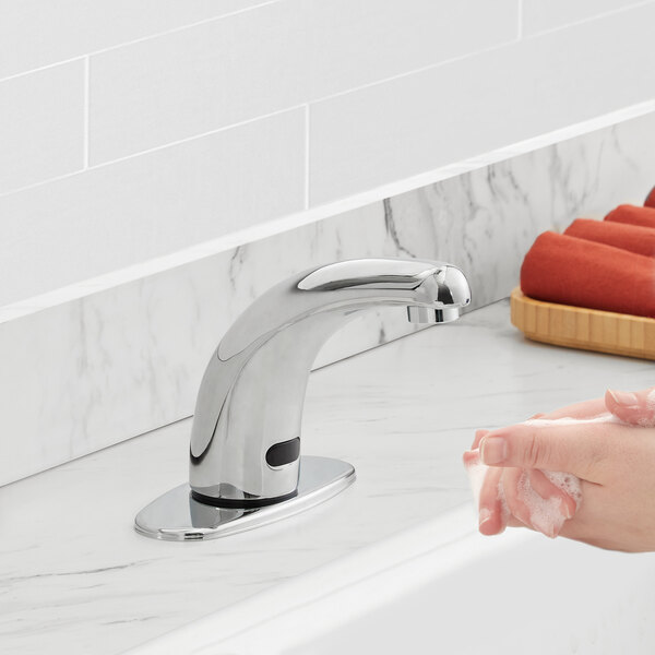 A person washing their hands with a Waterloo hands-free faucet.