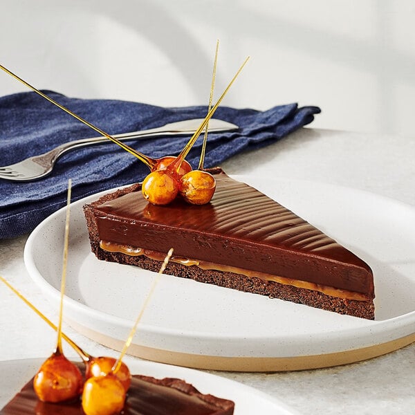 A piece of Ghirardelli dark chocolate cake with caramel toppings.