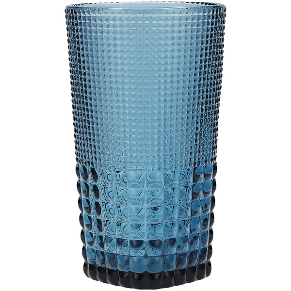 A close-up of a Fortessa Cornflower Blue beverage glass with a black rim.