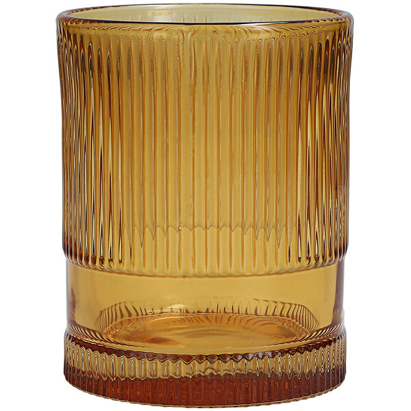 A close up of a Fortessa amber beverage glass with a brown stripe pattern.