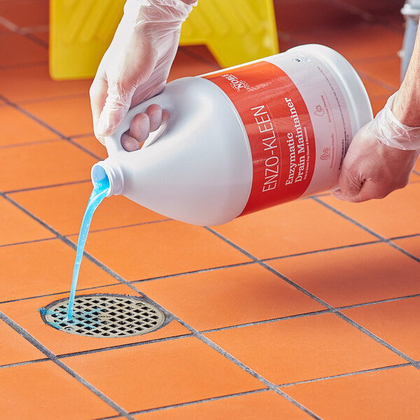 A person pouring Noble Eco Enzo-Kleen liquid into a drain.