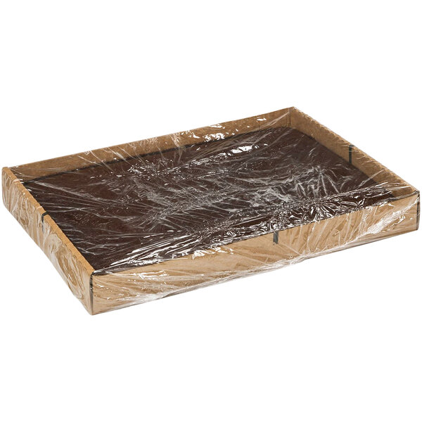 A brown box with plastic wrap on top with Rich's Un-Iced Chocolate Layer Cake inside.