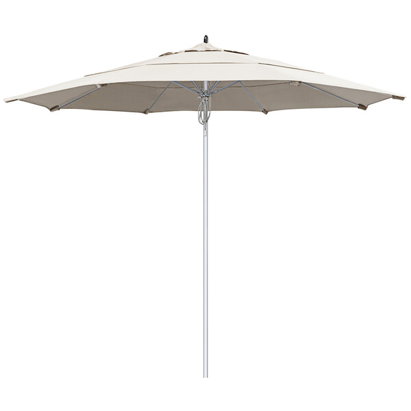A close-up of a white California Umbrella with a silver pole and natural Sunbrella fabric.