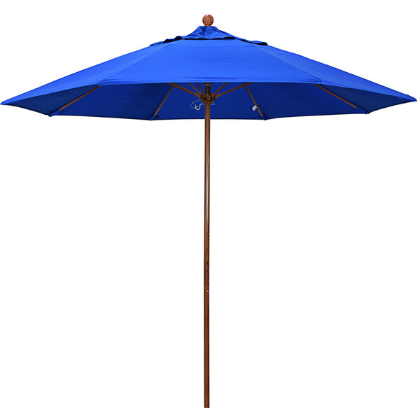A California Umbrella blue umbrella with a wooden pole.