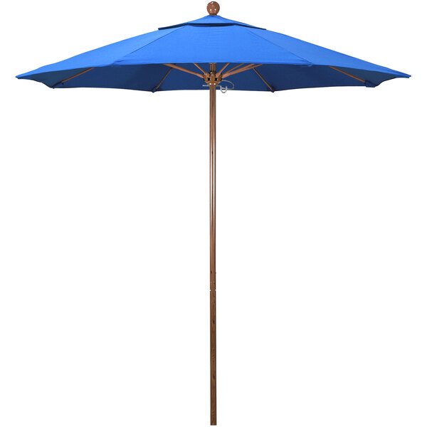 A California Umbrella royal blue umbrella with a wooden pole.