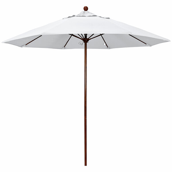 A white California Umbrella with a natural fabric canopy on an American oak pole.