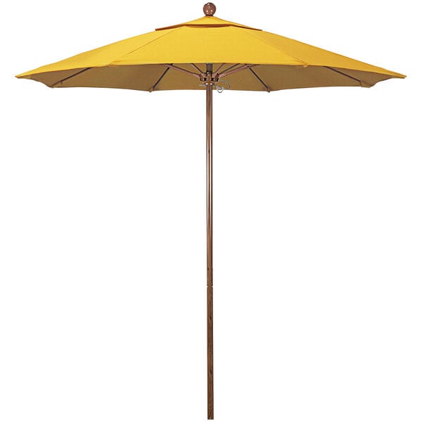 A yellow California Umbrella with a wooden pole.