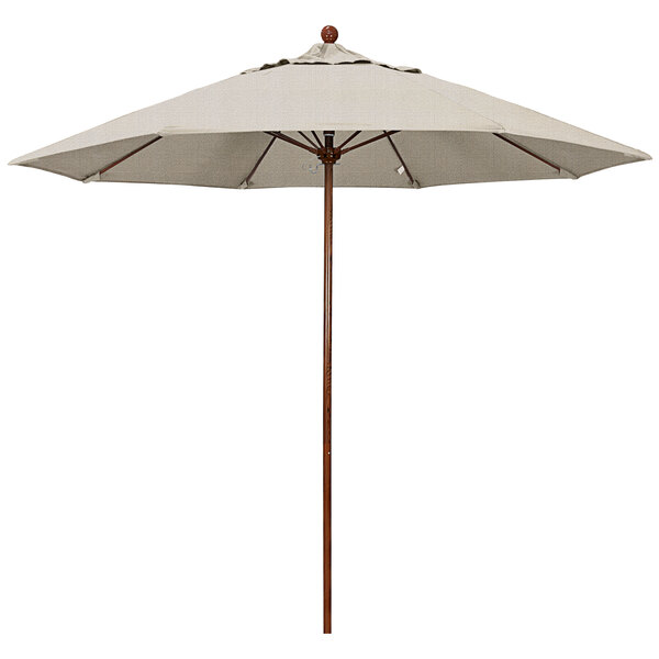 A California Umbrella Venture Series outdoor umbrella with a woven granite canopy and a wooden pole.
