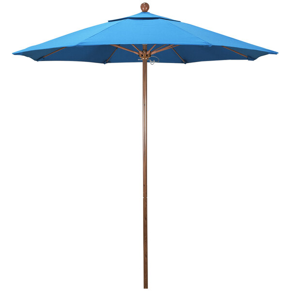 A cyan California Umbrella with a wooden pole.