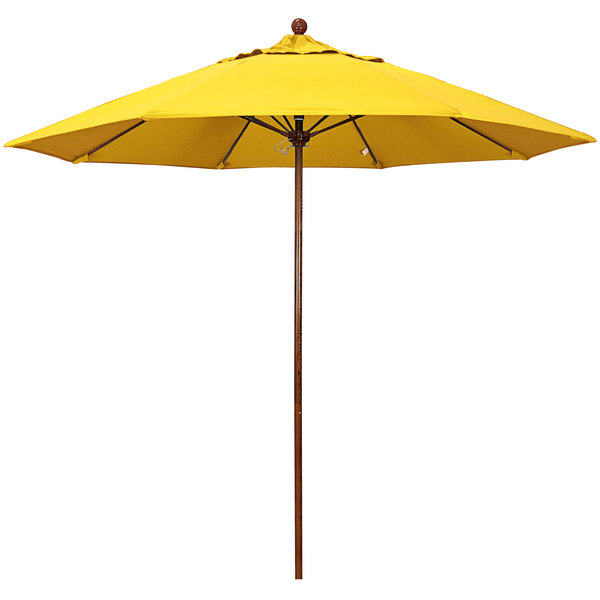 A yellow California Umbrella with a wooden pole.