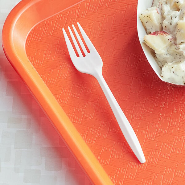 A white plastic fork on a plastic tray.