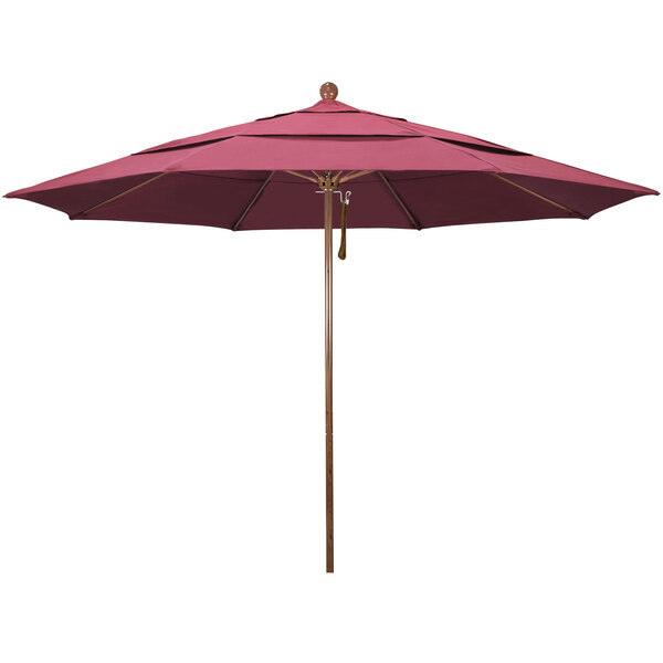 A hot pink California Umbrella with a brown pole.