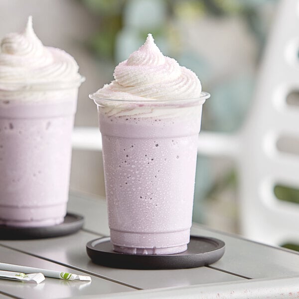 Two cups of purple Taro frappe on a table.