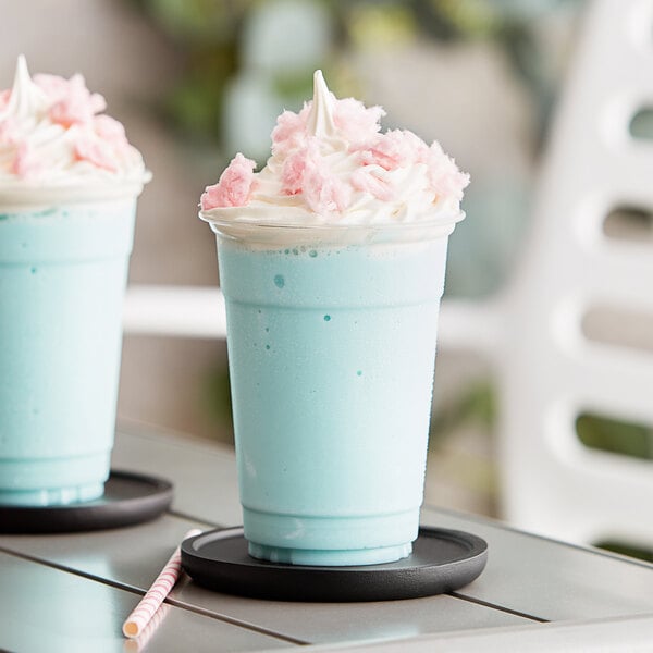 Two blue Capora Cotton Candy Frappe drinks with whipped cream and pink flakes.