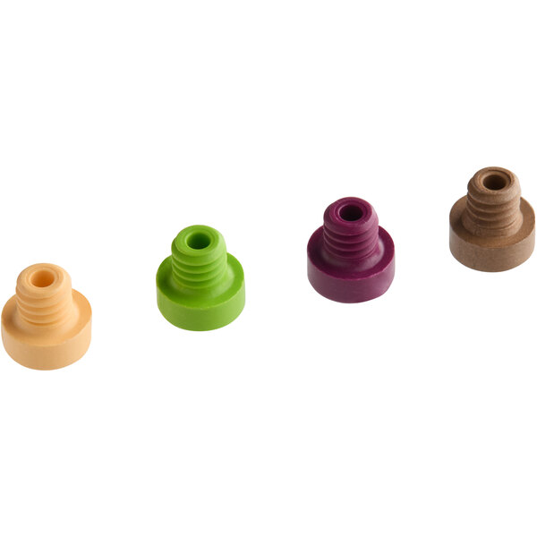 A group of green, brown, and red plastic round objects with a hole in the middle.