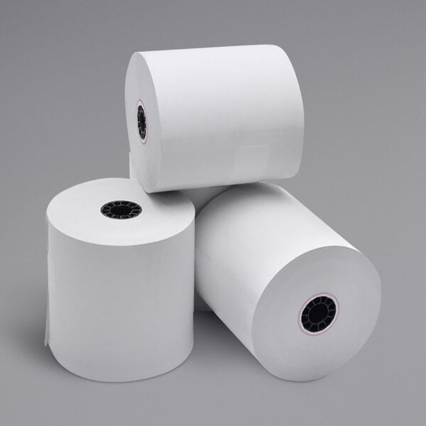 A stack of three white Point Plus thermal paper rolls.