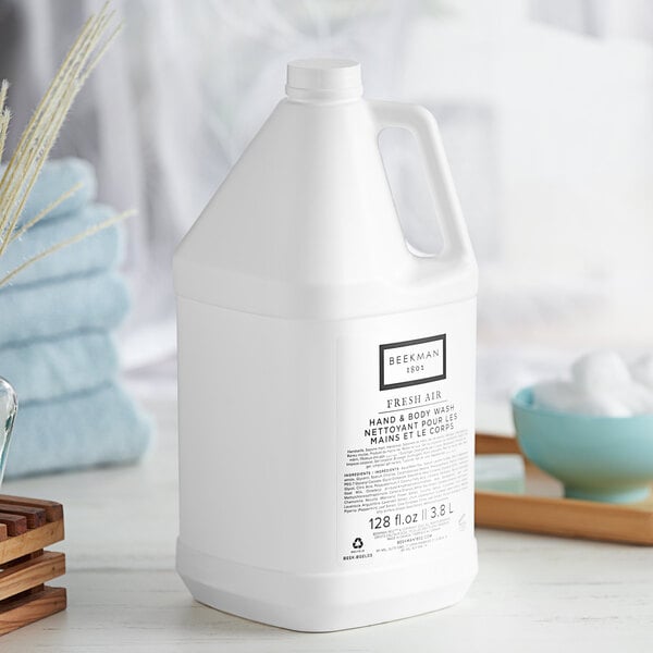 A white plastic jug of Beekman 1802 Fresh Air Body Wash on a table.