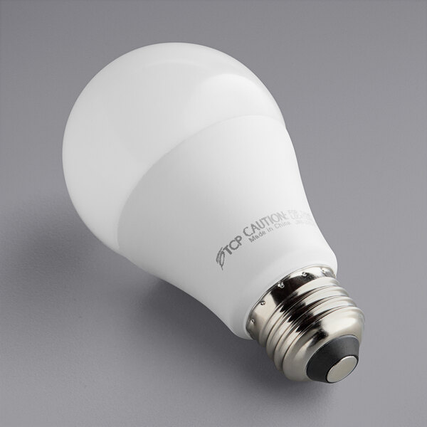 A TCP 10W dimmable LED light bulb with a 3500K white light on a gray surface.