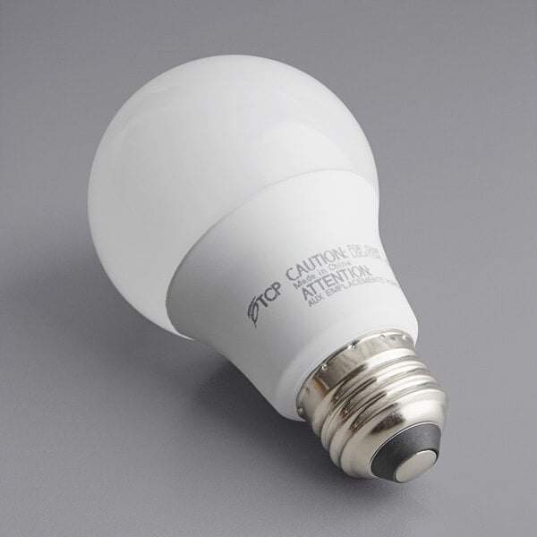 A TCP dimmable LED light bulb with a silver base and white label.