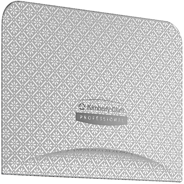 A close-up of a silver and white patterned faceplate for a Kimberly-Clark Professional toilet paper dispenser.