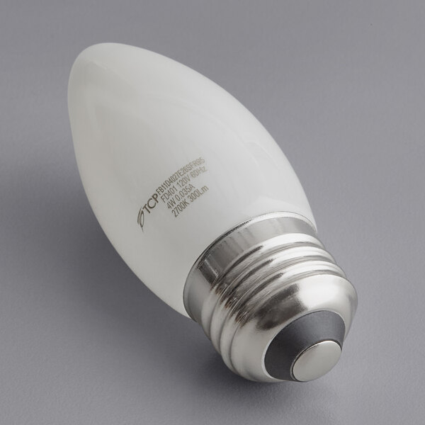 A TCP dimmable LED filament light bulb with a silver E26 base and round frosted glass.