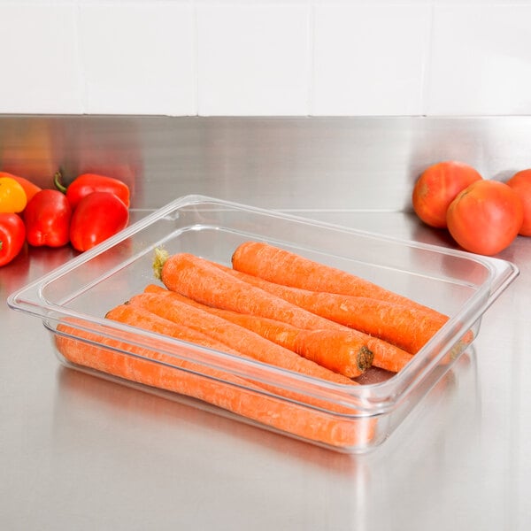 A clear plastic food pan with carrots in it.