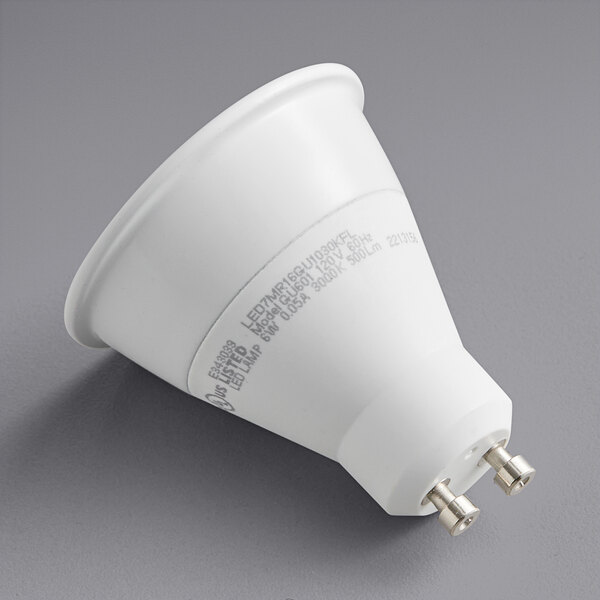 A TCP dimmable LED light bulb with silver tips on a white background.