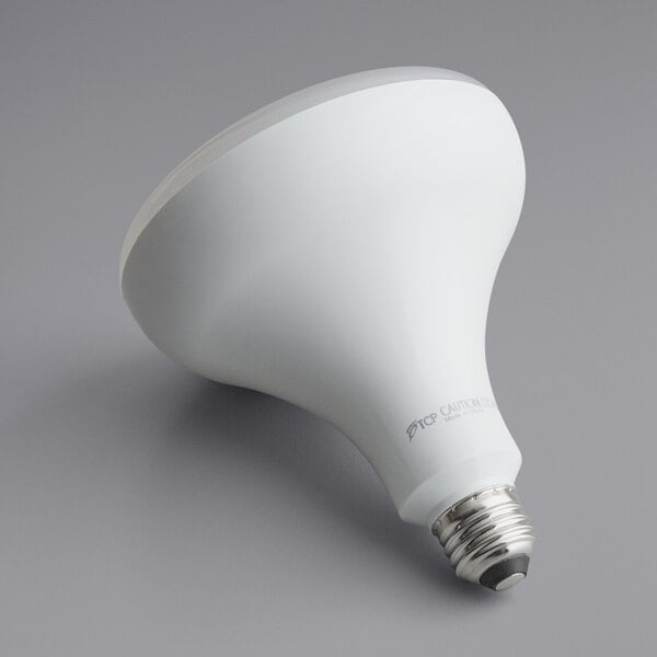 A TCP Elite dimmable LED light bulb with a white surface and a white light bulb.