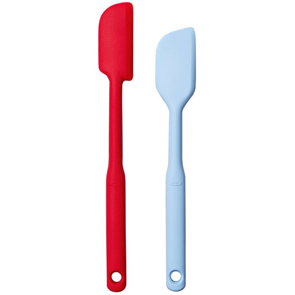 An OXO Good Grips spatula set with red and blue silicone heads and red handles.