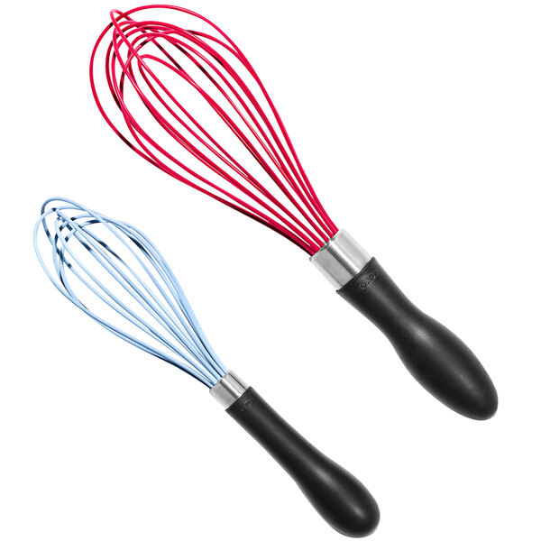 Two red and blue OXO Good Grips whisks with rubber handles.