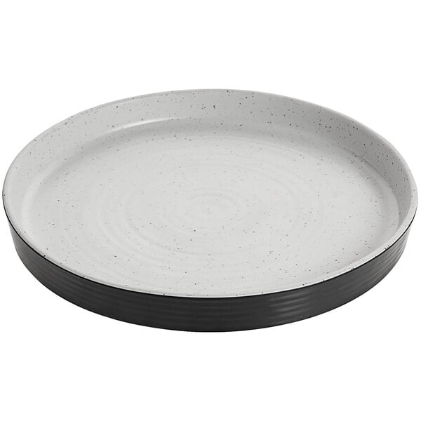 A white melamine plate with a black raised rim.